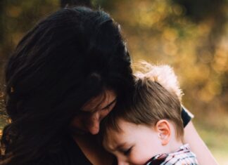 Mother cuddling her son