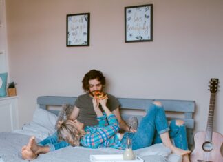 Parents sitting on bed