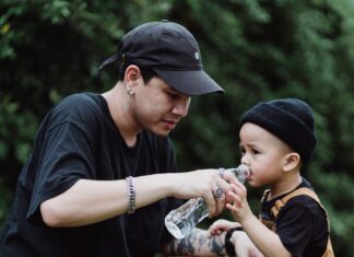 Dad giving water to kid