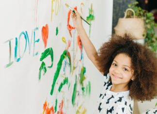 Girl painting on the walls