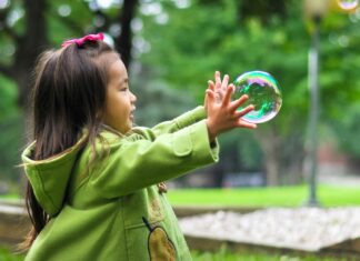 girl playing with bubbles