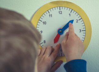 Child playing with toy clock