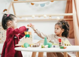 Babies playing with toys on a table