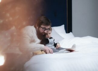 Father reading child a story in bed
