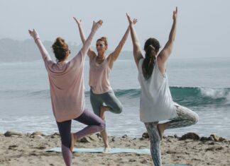 Group doing yoga on the beach