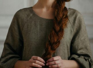 Woman touching thick red braid