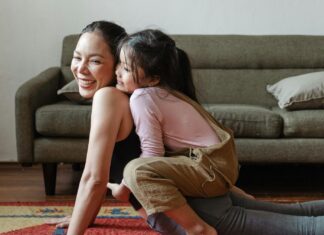 Photo of Girl Hugging Her Mom While Doing Yoga Pose