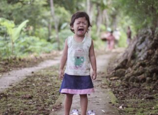 A girl cries losing her doll.
