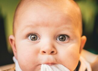 Young baby's wide reflective eyes