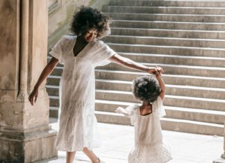 A Woman Holding Hands with her Daughter