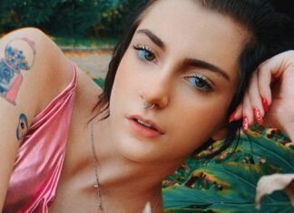 Girl in a Pink Shiny Tank Top Lying down in a Garden