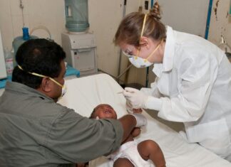 Baby Lying Down on Hospital Bed Getting a Check-up