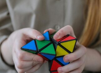 Girl showing bright brainteaser in hands