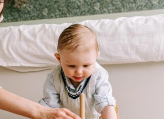 Mother and Baby Playing with Wooden Toy on the Floor