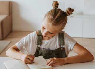 Little Girl Writing on a Notebook