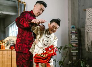 A Father and Son Playing with a Dragon Puppet