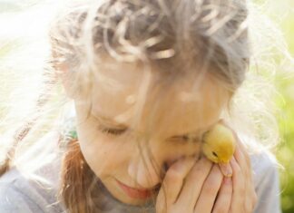 Girl holding a duckling