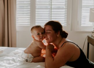 Woman with Her Baby in a Bed