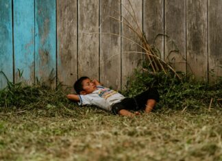 A Boy Sleeping in Grass