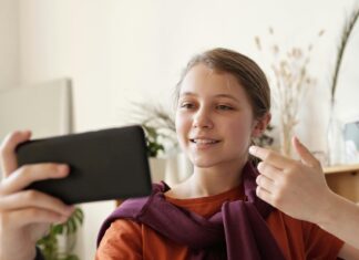 Photo of Girl Using Black Smartphone