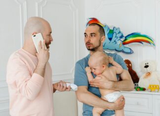 Two Men Feeling Worried Of Sick Baby