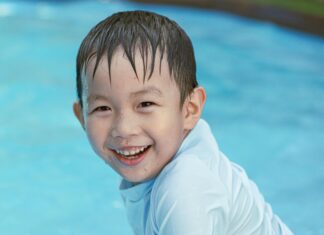 Smiling Boy Sitting in Water