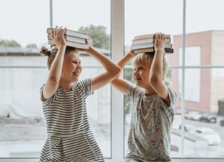 Brother and Sister With Books on Their Heads