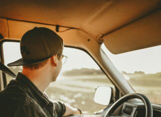 Man Wearing Black Denim Jacket in Driver's Seat