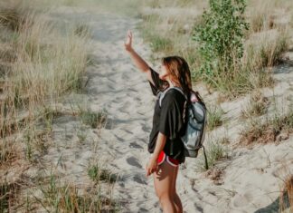 Girl Walking on Beach Protecting Eyes from Sun