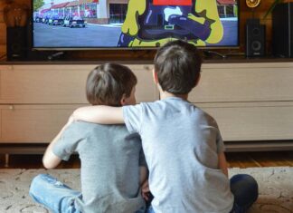 Faceless little boys entertaining with TV at home
